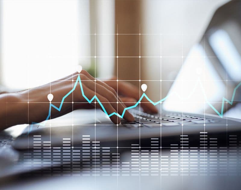 Close up photo of hands on a keyboard with a grid and graph overlaid on top